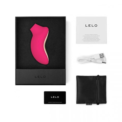 Kit completo de desempaque con accesorios, cable de carga y dispositivo Sona 2 Cruise fucsia.